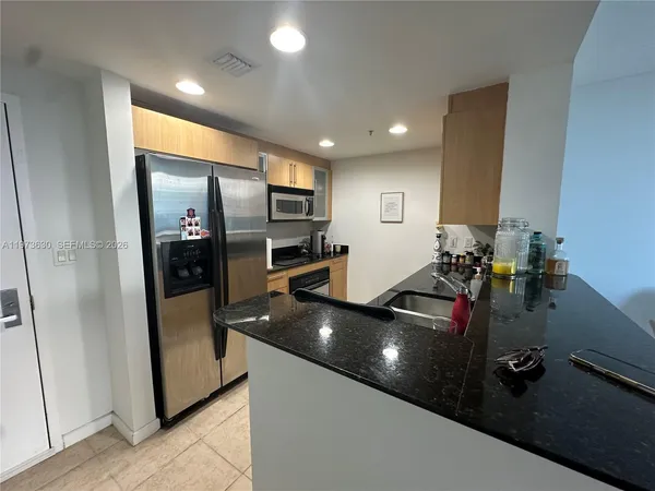 a kitchen with refrigerator and sink