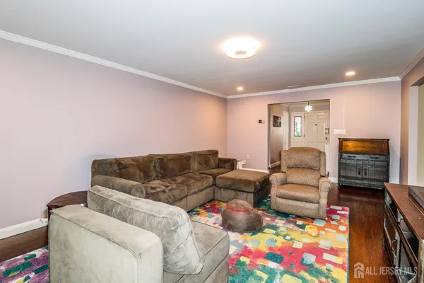 a living room with furniture a flat screen tv and a couch