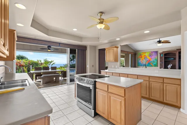 a kitchen with stainless steel appliances granite countertop a sink and a stove