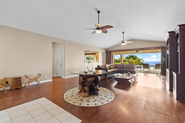 a living room with fireplace furniture and a wooden floor