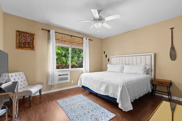 a bedroom with a large bed and a window