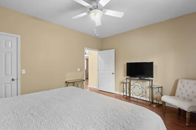 a bedroom with a bed and a flat screen tv