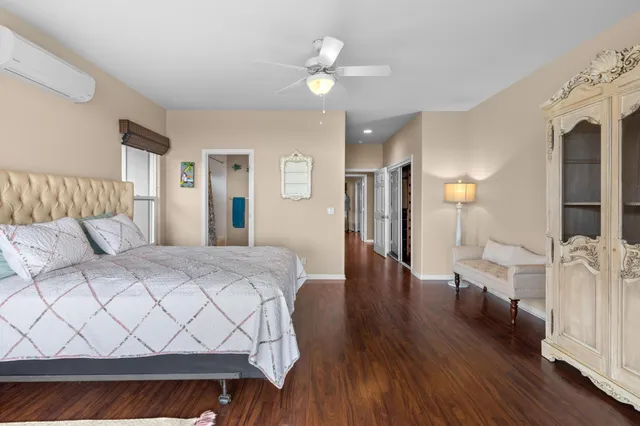 a spacious bedroom with a bed and a chandelier