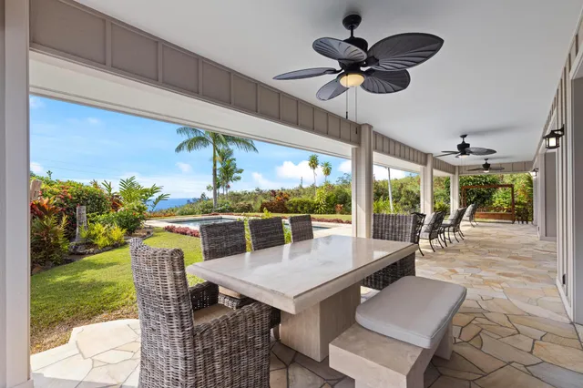 a view of a dining room with furniture wooden floor and garden view