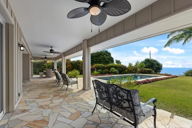 a view of a swimming pool with seating space