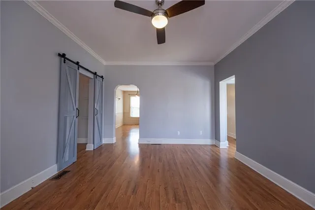 a view of an empty room with wooden floor