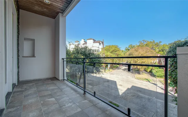 an entryway in a hall with a window and wooden floor