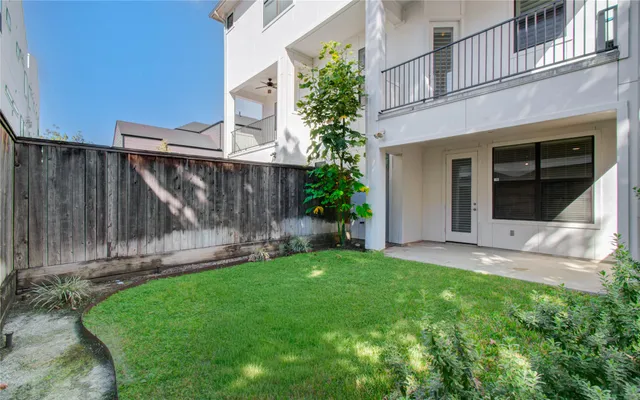 a view of back yard of the house with a yard