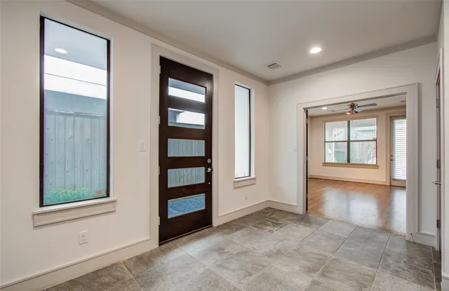 a view of an empty room and wooden floor