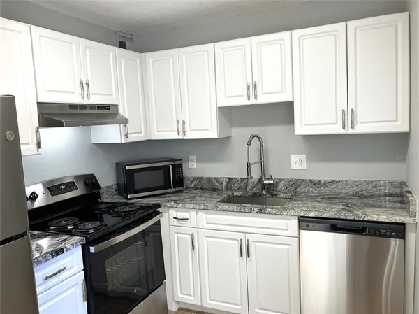 a kitchen with a sink and cabinets
