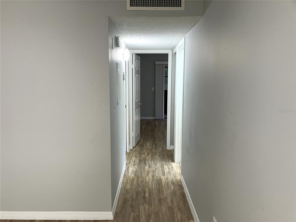 11703 Raintree Village Boulevard, Unit B Temple Terrace, FL 33617 - Photo 27 of 60 a view of a hallway with wooden floor