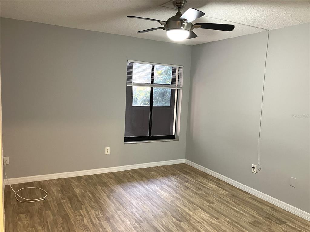 11703 Raintree Village Boulevard, Unit B Temple Terrace, FL 33617 - Photo 28 of 60 wooden floor in an empty room with a window