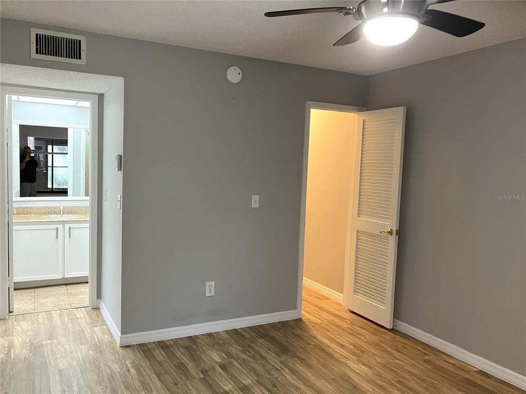 11703 Raintree Village Boulevard, Unit B Temple Terrace, FL 33617 - Photo 31 of 60 a view of an empty room with wooden floor and a window