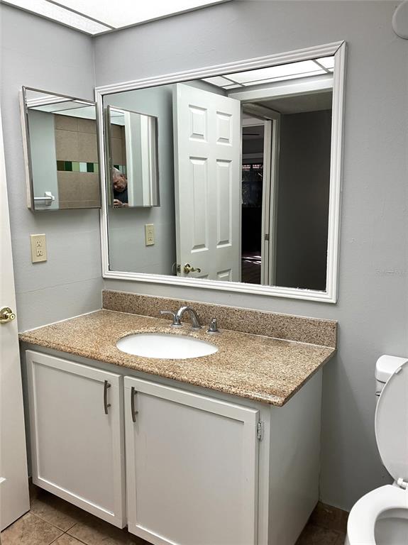 11703 Raintree Village Boulevard, Unit B Temple Terrace, FL 33617 - Photo 34 of 60 a bathroom with a granite countertop sink and a mirror