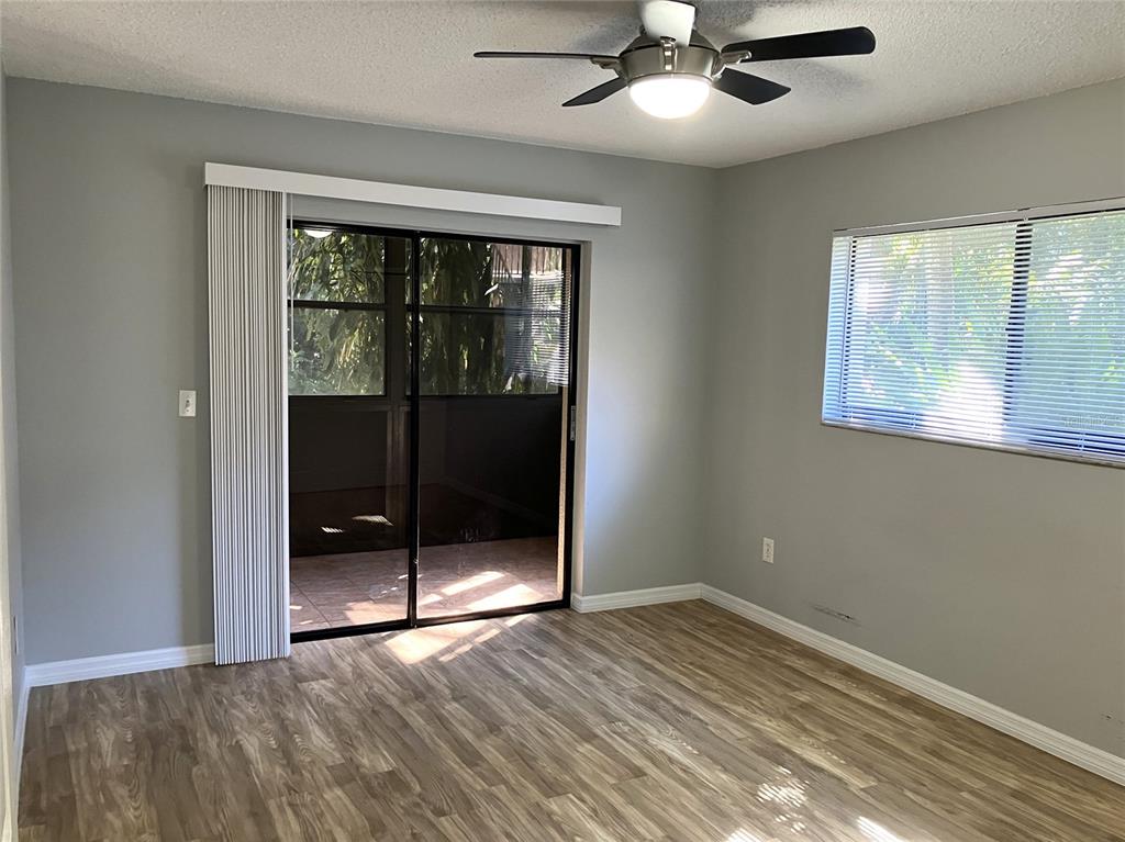 11703 Raintree Village Boulevard, Unit B Temple Terrace, FL 33617 - Photo 38 of 60 a view of an empty room with window and wooden floor