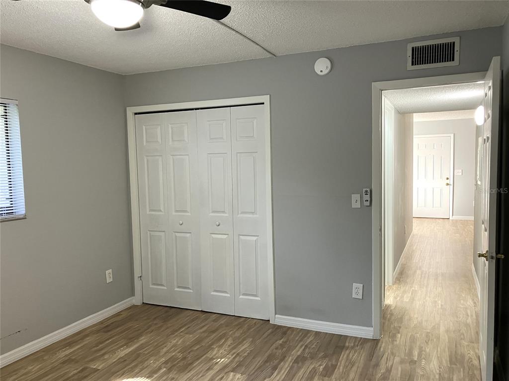 11703 Raintree Village Boulevard, Unit B Temple Terrace, FL 33617 - Photo 40 of 60 a view of an empty room with wooden floor