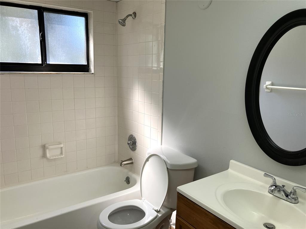 11703 Raintree Village Boulevard, Unit B Temple Terrace, FL 33617 - Photo 42 of 60 a bathroom with a sink and a mirror