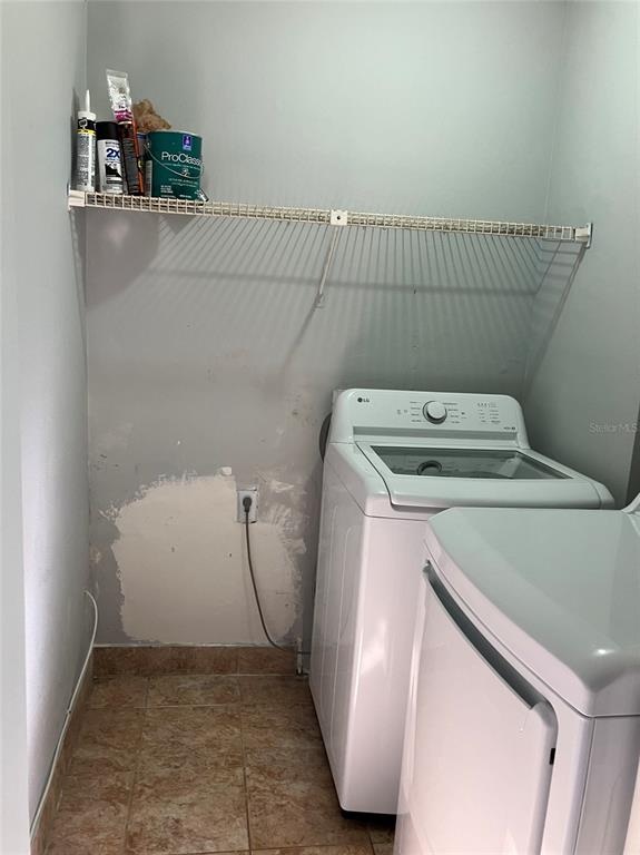 11703 Raintree Village Boulevard, Unit B Temple Terrace, FL 33617 - Photo 44 of 60 a utility room with dryer and washer