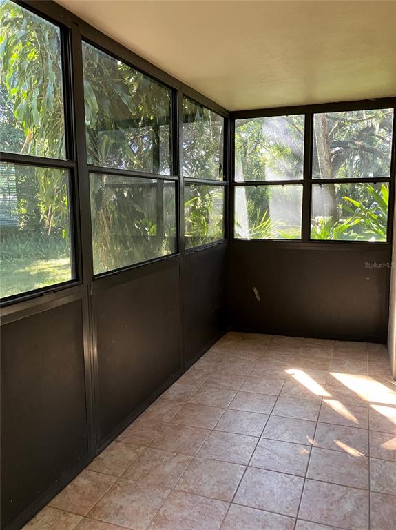 11703 Raintree Village Boulevard, Unit B Temple Terrace, FL 33617 - Photo 46 of 60 an empty room with large windows