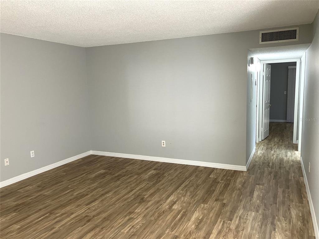 11703 Raintree Village Boulevard, Unit B Temple Terrace, FL 33617 - Photo 10 of 60 a view of an empty room with wooden floor