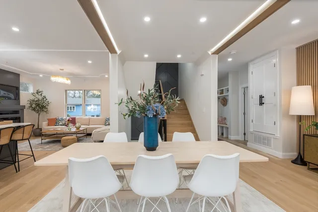 a dining room with furniture and wooden floor