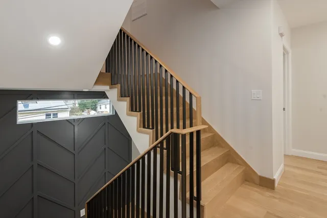 a view of entryway and hall with wooden floor