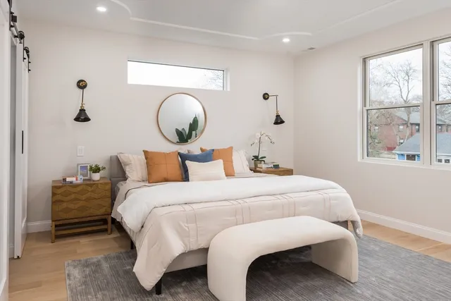 a bedroom with bed and window