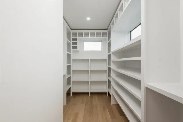 a view of a room with a closet and wooden floor