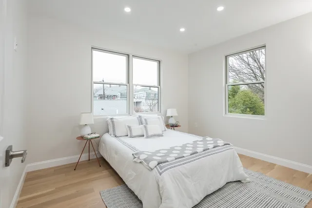 a large bedroom with a bed and a window