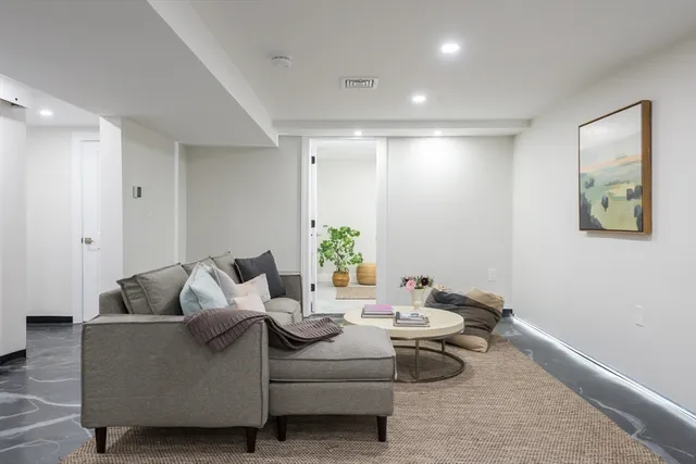 a living room with furniture and a potted plant