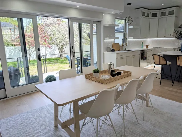 a dining room with furniture window and wooden floor