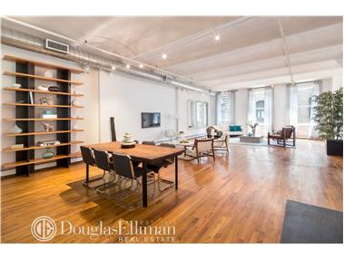 a living room with furniture and a table with wooden floor