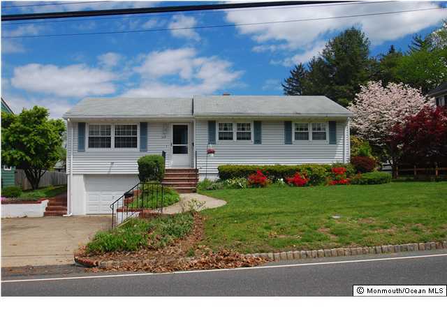 609 Holmdel Road Hazlet, NJ 07730 - Photo 1 of 3 a front view of a house with a garden