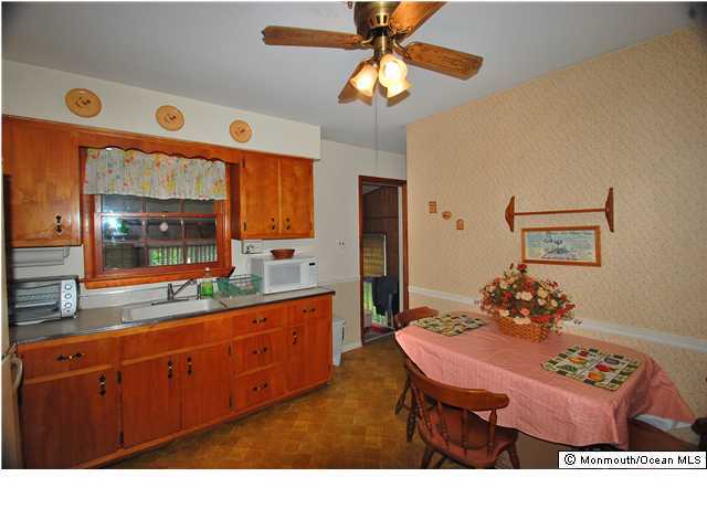 609 Holmdel Road Hazlet, NJ 07730 - Photo 2 of 3 a living room with stainless steel appliances kitchen island granite countertop furniture and a large window