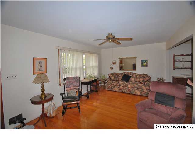609 Holmdel Road Hazlet, NJ 07730 - Photo 3 of 3 a living room with furniture and a dining table
