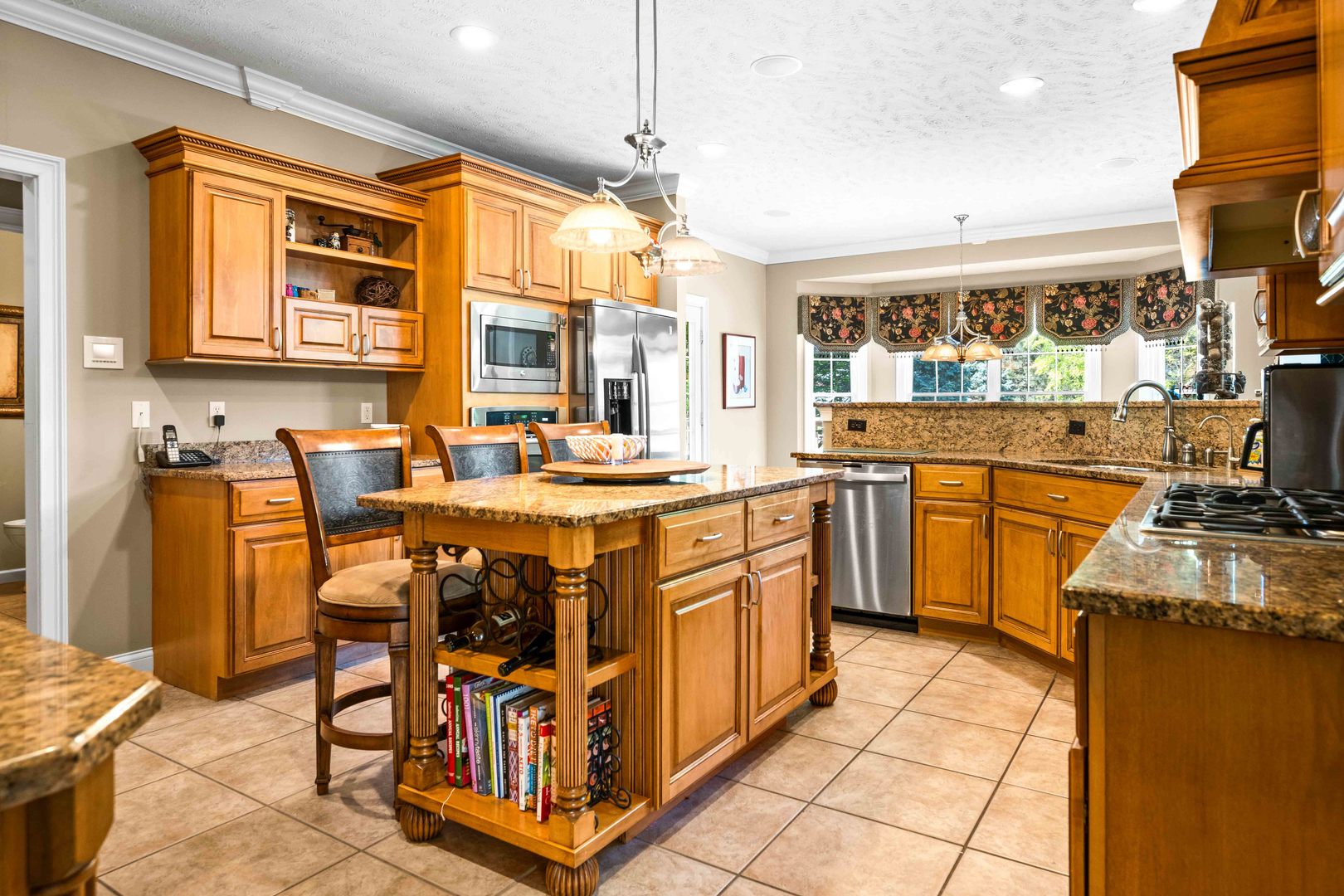 4 Derby Way Bloomington, IL 61704 - Photo 15 of 56 a kitchen with stainless steel appliances granite countertop a stove a sink dishwasher and cabinets with wooden floor