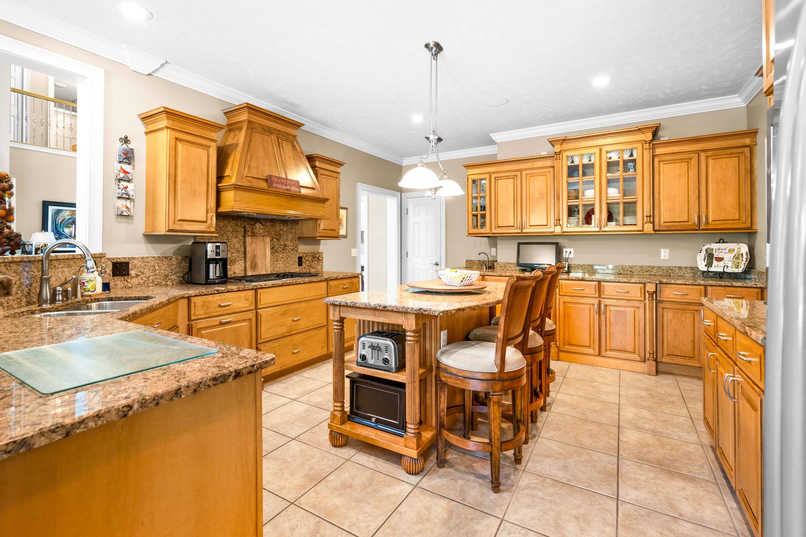 4 Derby Way Bloomington, IL 61704 - Photo 16 of 56 a dining hall with stainless steel appliances kitchen island granite countertop a sink and cabinets