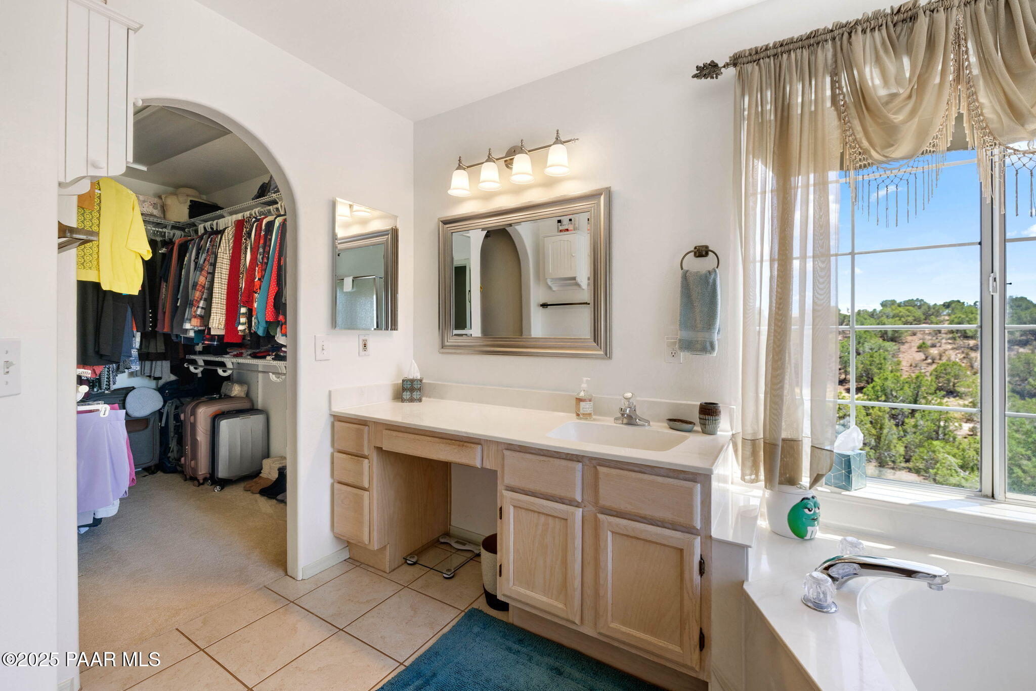 5400 North Skyhawk Road Chino Valley, AZ 86323 - Photo 15 of 26 a bathroom with a double vanity sink a mirror and a bathtub