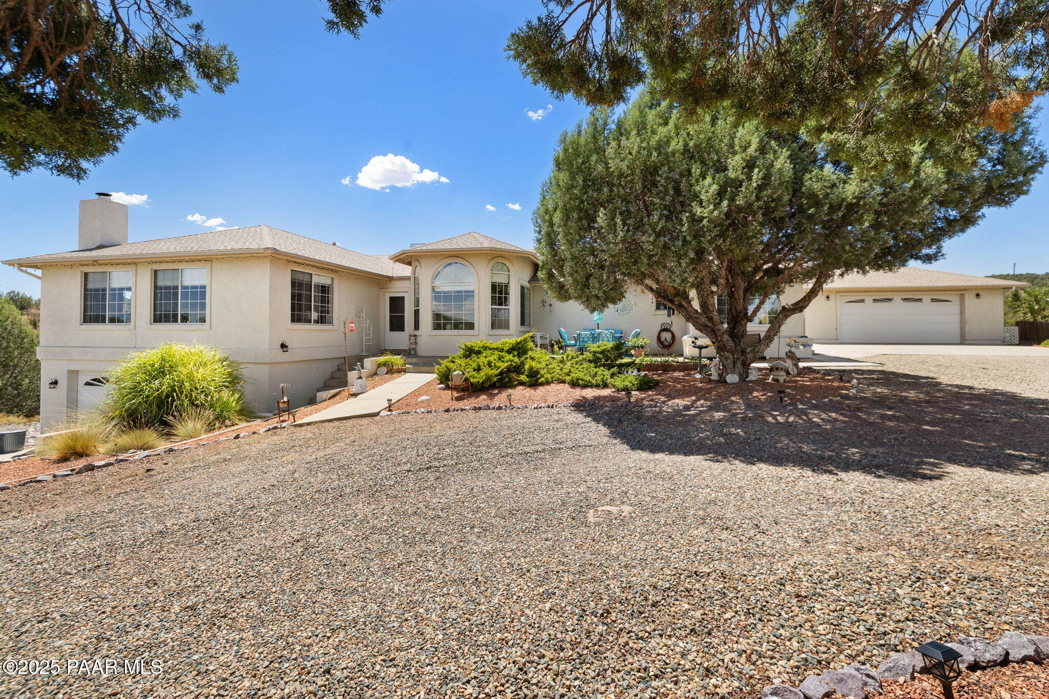 5400 North Skyhawk Road Chino Valley, AZ 86323 - Photo 2 of 26 a front view of a house with a yard and a garage