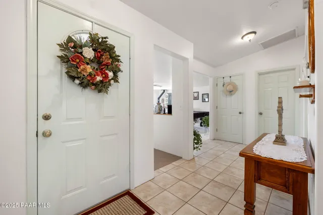 a bedroom with furniture and a large window