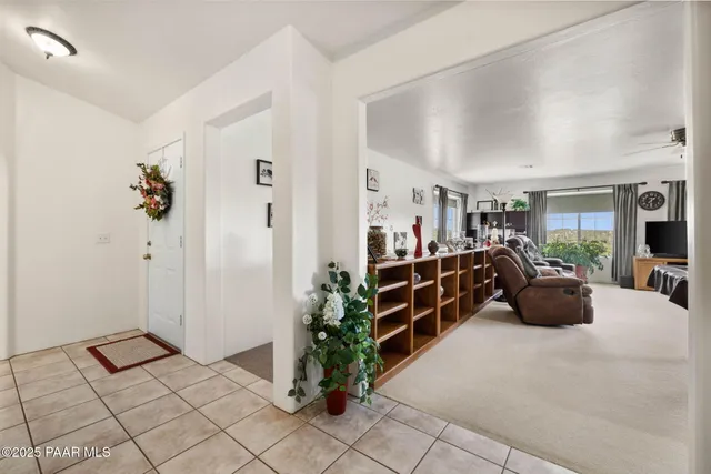 a living room with furniture a chandelier and a dining table
