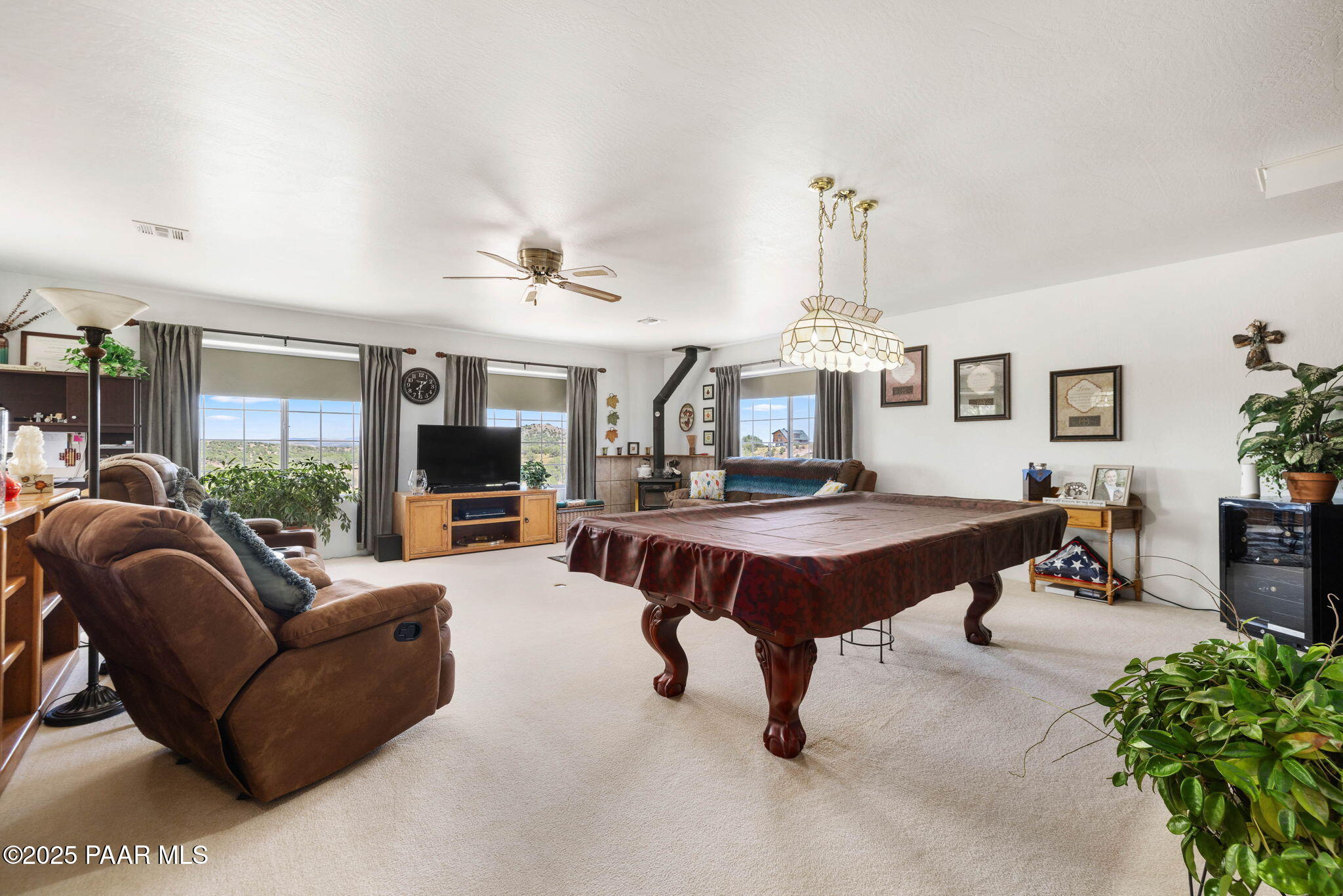 5400 North Skyhawk Road Chino Valley, AZ 86323 - Photo 5 of 26 a living room with furniture a chandelier and a dining table
