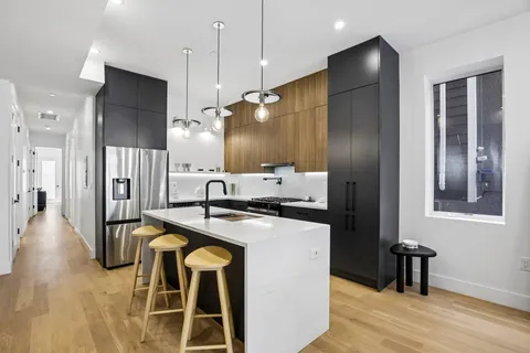 a kitchen with stainless steel appliances granite countertop a stove a refrigerator and a sink
