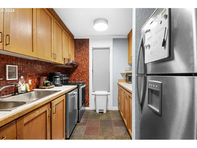 a kitchen with a refrigerator a sink and dishwasher