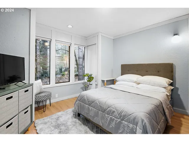 a bedroom with a large bed and a flat screen tv