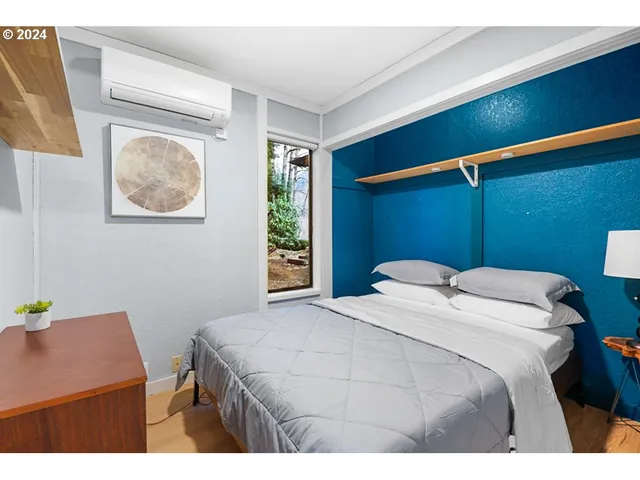 a bedroom with a bed and a window