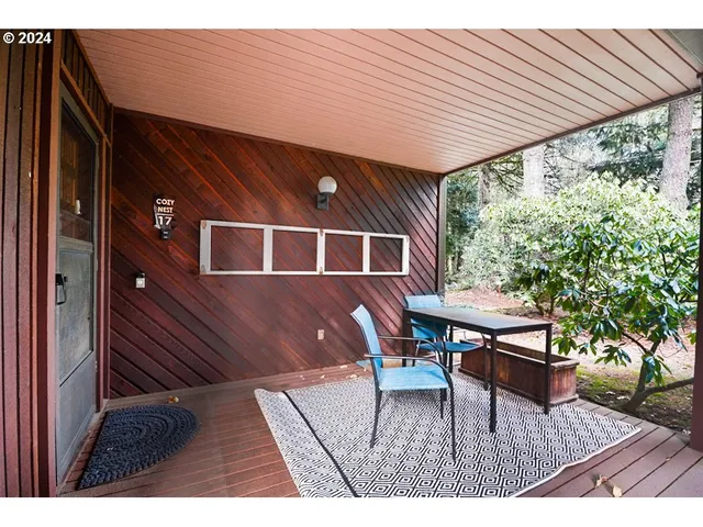 a backyard of a house with table and chairs