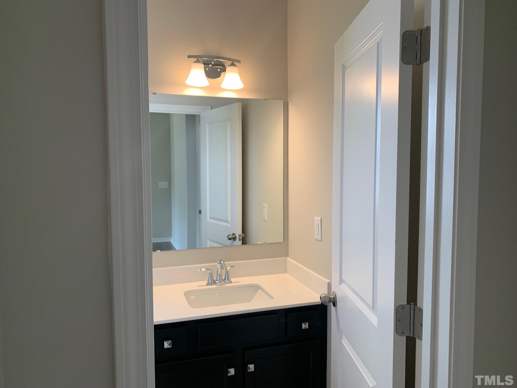 7104 Commodity Court Mebane, NC 27302 - Photo 14 of 32 a bathroom with a sink and a mirror
