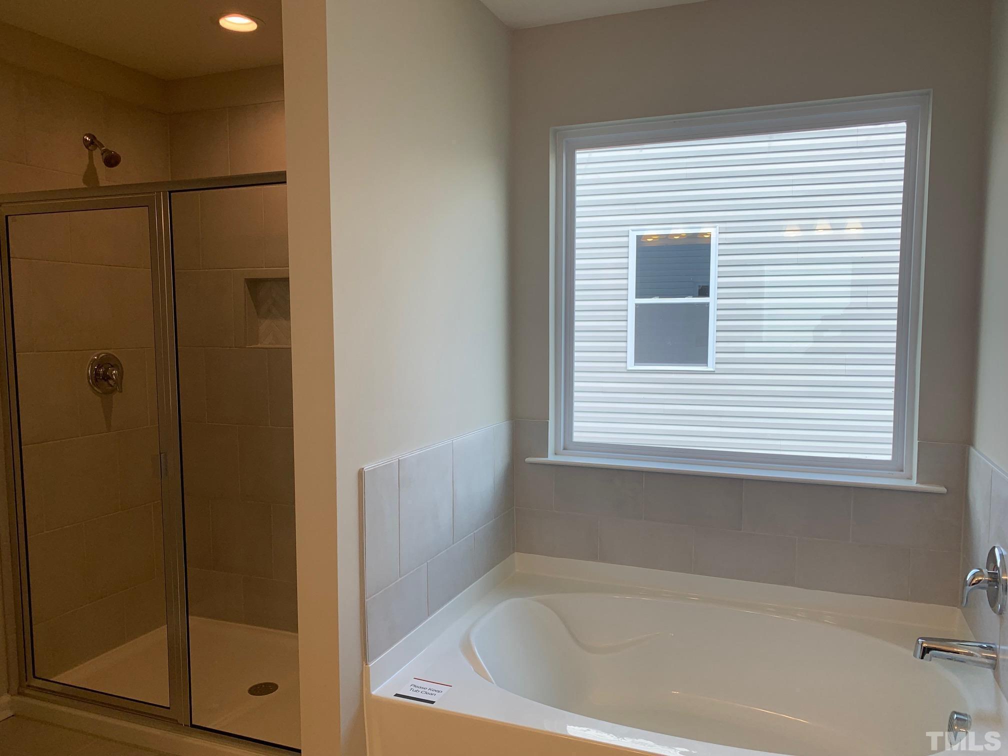 7104 Commodity Court Mebane, NC 27302 - Photo 20 of 32 a bathroom with a bathtub and a shower