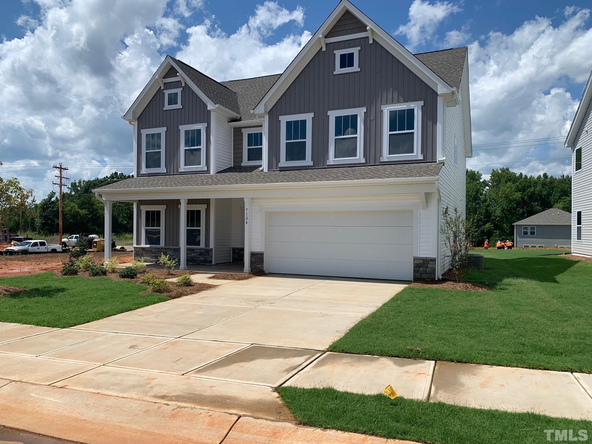 7104 Commodity Court Mebane, NC 27302 - Photo 2 of 32 a front view of a house with a yard and garage